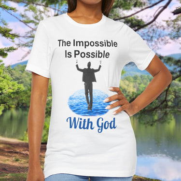 Soft, breathable Bella+Canvas t-shirt made from preshrunk cotton with “Impossible Man” design message, “The Impossible Is Possible With God,” inspirational shirt encouraging bold faith to step out and follow God into the impossible, woman in white t-shirt